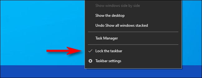 Haga clic derecho en la barra de tareas y desmarque "Bloquear la barra de tareas."