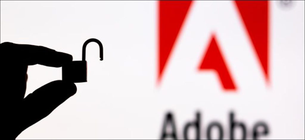 Una silueta de una mano que sostiene un candado abierto frente a un logotipo de Adobe.