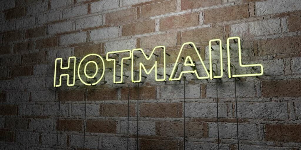 Hotmail Glowing Neon Sign On Stonework Wall