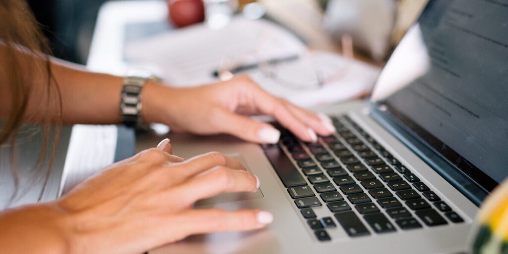 Woman typing at computer