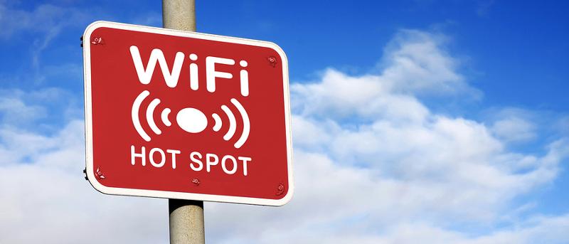 WiFi hotspot sign against a blue sky